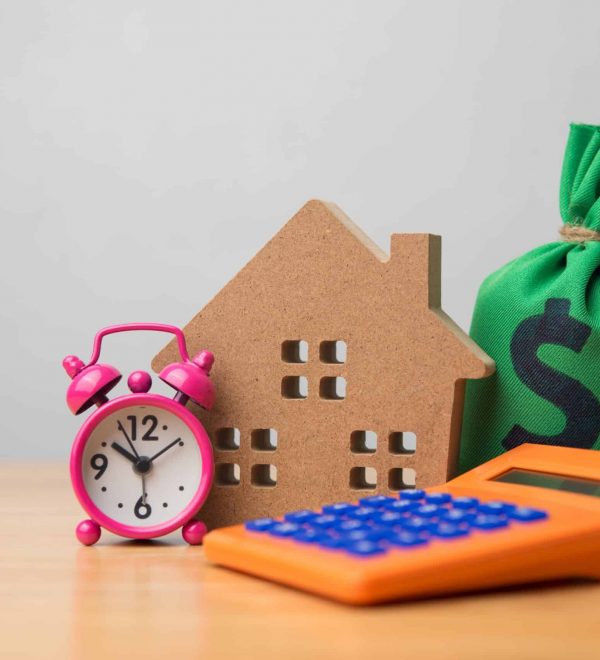 A home, bag of money, calculator and alarm clock signifying time to use CEMA for mortgage consolidation.