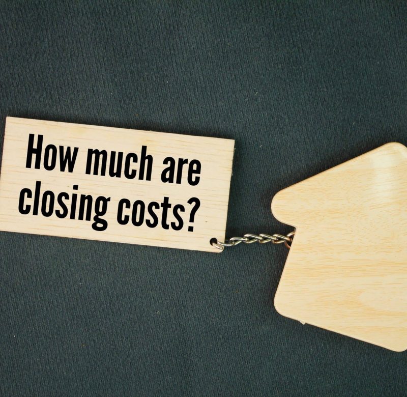 Wood tag asking a common question related to residential closings in New York.